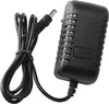 A black power adapter with a coiled black cable and a connector. Voir les images du produit