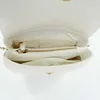 The interior of a white quilted handbag is shown. Anteprima dell’immagine prodotto
