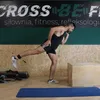A man is performing a leg exercise with resistance bands in a gym. Náhled obrázku produktu