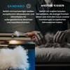 A split image comparing two types of pillow fillings. The left side shows high-quality white down and feathers for Sandaro pillows, while the right side shows less comfortable brown goose feathers for other pillows. Produktbild-Vorschau