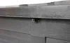 A close-up view of a dark gray plastic garden bench, focusing on a small metal clip attached to the underside of the top surface. Produktbild-Vorschau