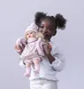 A young girl is holding a doll. Anteprima dell’immagine prodotto