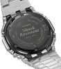 Close-up of the back of a silver and black watch, showing engraved text and logos. Náhled obrázku produktu