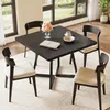 A dark wood dining table with four chairs, set in a bright room with large windows. Náhľad obrázku produktu