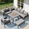 A patio set on a deck with a white railing and green grass in the background. Produktbild-Vorschau
