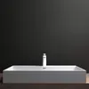 A white rectangular sink with a white faucet against a dark gray background. Produktbild-Vorschau