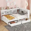 A white wooden bed with built-in shelves and drawers, decorated with children's items and set against a pink wall. Náhled obrázku produktu