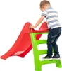 A young child is climbing up a red and green plastic slide. Anteprima dell’immagine prodotto