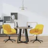 A dining set with two yellow velvet chairs and a round wooden table in a room with bookshelves. Náhled obrázku produktu