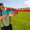 A young person holding a toy gun outdoors. Produktbild-Vorschau