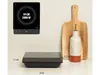 An induction cooktop is shown next to kitchen accessories, with dimensions indicated. Voir les images du produit