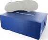 A shoe is placed on top of a blue shoebox. Produktbild-Vorschau