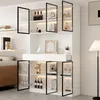 A modern white display cabinet with glass doors and LED lighting, showcasing various decorative items and bottles. Produktbild-Vorschau