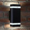 A black LED wall light mounted on a brick wall. Podgląd zdjęcia produktu