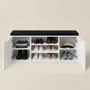 A white shoe cabinet with a black upholstered seat on top, filled with shoes and folded clothes. Náhľad obrázku produktu