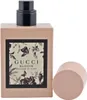 Gucci Bloom Flakon ohne Kappe, zeigt schwarzen Sprühkopf und florales Etikett mit Schmetterlingen und Blüten. Podgląd zdjęcia produktu