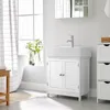 A white bathroom vanity with a sink and faucet, next to a window with a checkered curtain and a bathtub. Produktbild-Vorschau