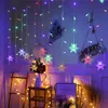 A festive indoor scene decorated with snowflake string lights, a vase of flowers, and a wooden ladder. Náhled obrázku produktu