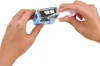 Hands holding a blue stamp and a clear plastic tool, with the tool being inserted into the stamp. Podgląd zdjęcia produktu