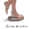 A person's feet are shown stepping on a decorative stone disc that resembles a tree stump. Anteprima dell’immagine prodotto