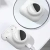 A white silicone case for AirPods with a slot for an AirTag is shown, with a charging cable attached. Náhled obrázku produktu