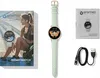 A flat lay of a smartwatch, its packaging, and accessories against a white background. Voir les images du produit