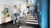 A split image showing a man vacuuming in a hallway and on stairs. Produktbild-Vorschau