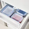 Three food storage containers in a refrigerator drawer. Produktbild-Vorschau