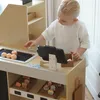 A child playing with a wooden market stand. Produktbild-Vorschau