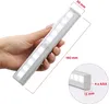 A hand holding a white LED light bar with motion sensor. Produktbild-Vorschau