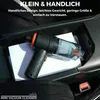 A mini vacuum cleaner is placed inside a car's center console storage compartment. Produktbild-Vorschau