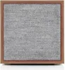 A square speaker with a wooden frame and a gray fabric front, presented on a white background. Produktbild-Vorschau