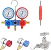 A collection of air conditioning diagnostic tools, including a manifold gauge set, adapters, and a valve core tool, arranged on a white background. Produktbild-Vorschau