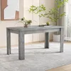 A dining table is set in a room with a rug and a plant. Anteprima dell’immagine prodotto