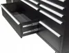 A close-up view of an open drawer in a black tool chest, showing the drawer slides and the interior of the drawer. Produktbild-Vorschau