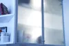A close-up view of frosted glass cabinet doors with some items visible inside. Produktbild-Vorschau