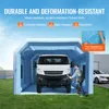 An inflatable spray booth with a van inside, a person working on the van, and a car parked nearby. Anteprima dell’immagine prodotto