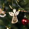 Close-up of a wooden angel Christmas ornament hanging on a Christmas tree, with a red ornament and fairy lights in the background. Produktbild-Vorschau