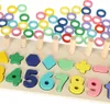 A wooden Montessori toy with colorful shapes and numbers arranged on a board, with rings stacked on pegs. Produktbild-Vorschau