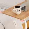 A wooden tray table with a laptop and a mug on it, placed over a bed. Produktbild-Vorschau