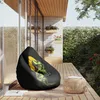 A bean bag chair with a dinosaur print sits on a wooden deck next to a small round table. Náhľad obrázku produktu