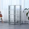A gray, multi-shelf storage unit is shown in a room with sheer curtains in the background. Produktbild-Vorschau