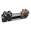 A black metal shoe rack mounted on a wall, holding two pairs of shoes. Produktbild-Vorschau