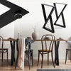A dining table with black metal legs and chairs, set with plates and candles. Náhľad obrázku produktu