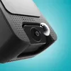 A close-up shot of a black dashcam with a water droplet on the lens. Produktbild-Vorschau