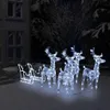 A nighttime outdoor scene with illuminated Christmas decorations. Podgląd zdjęcia produktu
