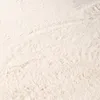 A close-up view of a fluffy, cream-colored rug. Produktbild-Vorschau