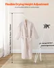 A beige robe is hanging on a white drying rack, with a measurement scale indicating adjustable height. Anteprima dell’immagine prodotto