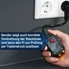 A hand holding a black electrical tester plugged into a wall socket. Náhľad obrázku produktu