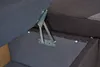 A close-up view of the internal hinge mechanism of a storage bench or sofa. Produktbild-Vorschau